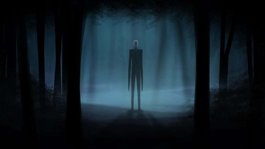 Slenderman stands in a dark misty forest at night with eerie blue lighting. — Horror Background