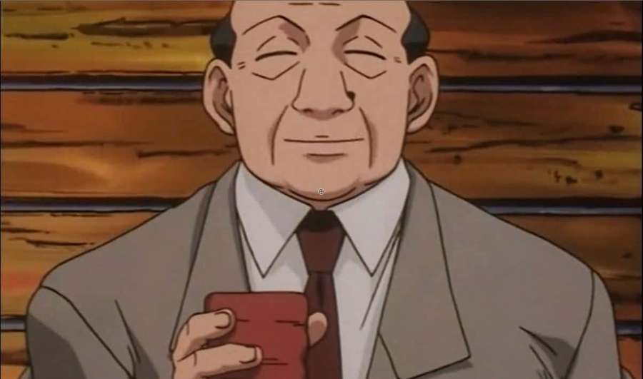 An elderly man in a suit smiles while holding a red cup against a wooden wall. — Hunter X Hunter Zebro Wallpaper