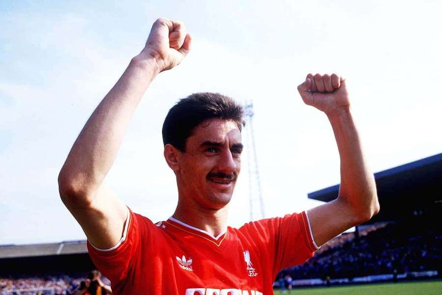 Football player celebrating victory with raised fists in a stadium. — Ian Rush Wallpaper