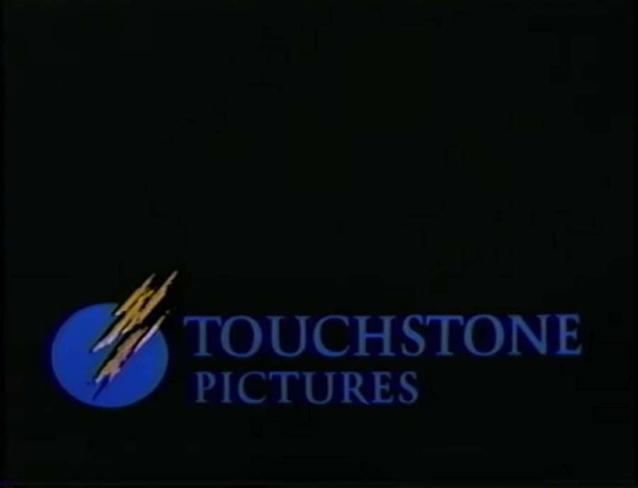 Logotipo da Touchstone Pictures com texto azul e emblema circular em fundo escuro. — Imagem Touchstone Fotos