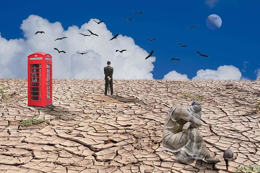 Man standing on cracked earth near red phone booth with birds flying and moon in sky — Indifferent Picture