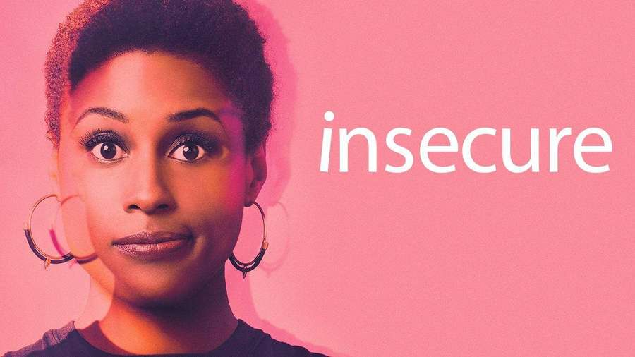 Woman with short hair and hoop earrings stares with intense expression against pink background with word insecure. — Insecure Wallpaper