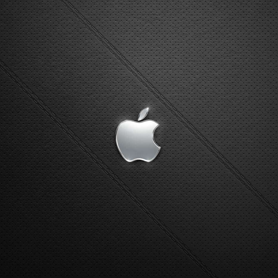 Kiiltävä Apple-logo mustalla rei'itetyllä nahalla, jossa ompeleet. — iPad 2 Taustakuvat