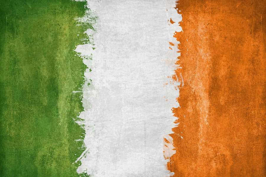 Ireland flag painted on concrete with textured brushstrokes — Irish Background