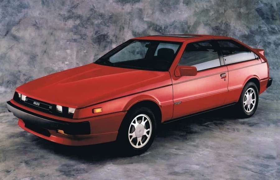 Red Isuzu Impulse coupe in studio with gray textured background — Isuzu Impulse Wallpaper