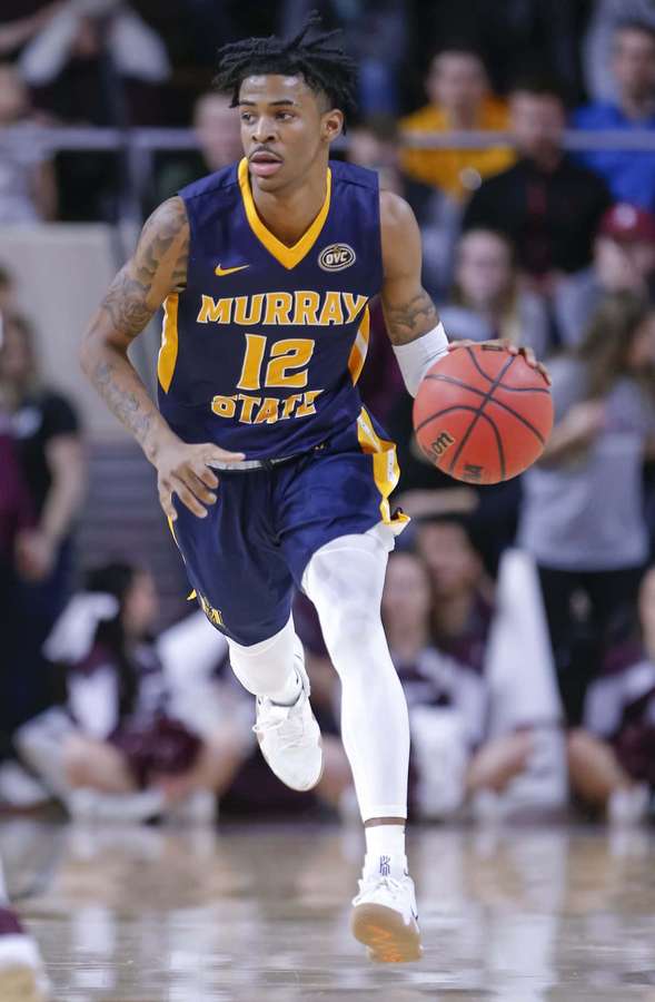 Basketball player dribbling during a game in a purple and gold uniform. — Ja Morrant Wallpaper