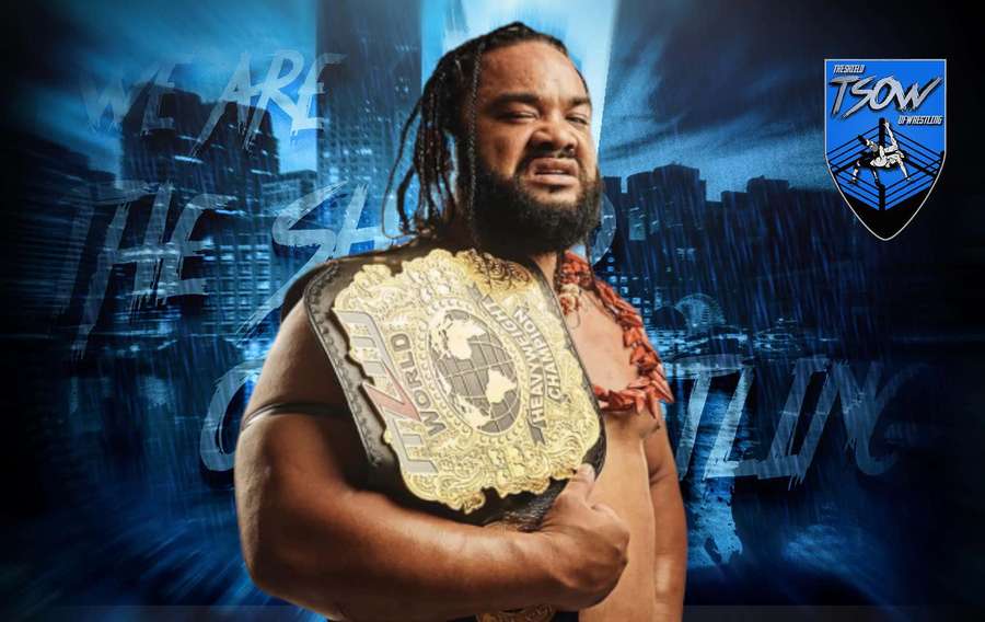 Wrestler holding championship belt in glowing blue cityscape background. — Jacob Fatu Wallpaper
