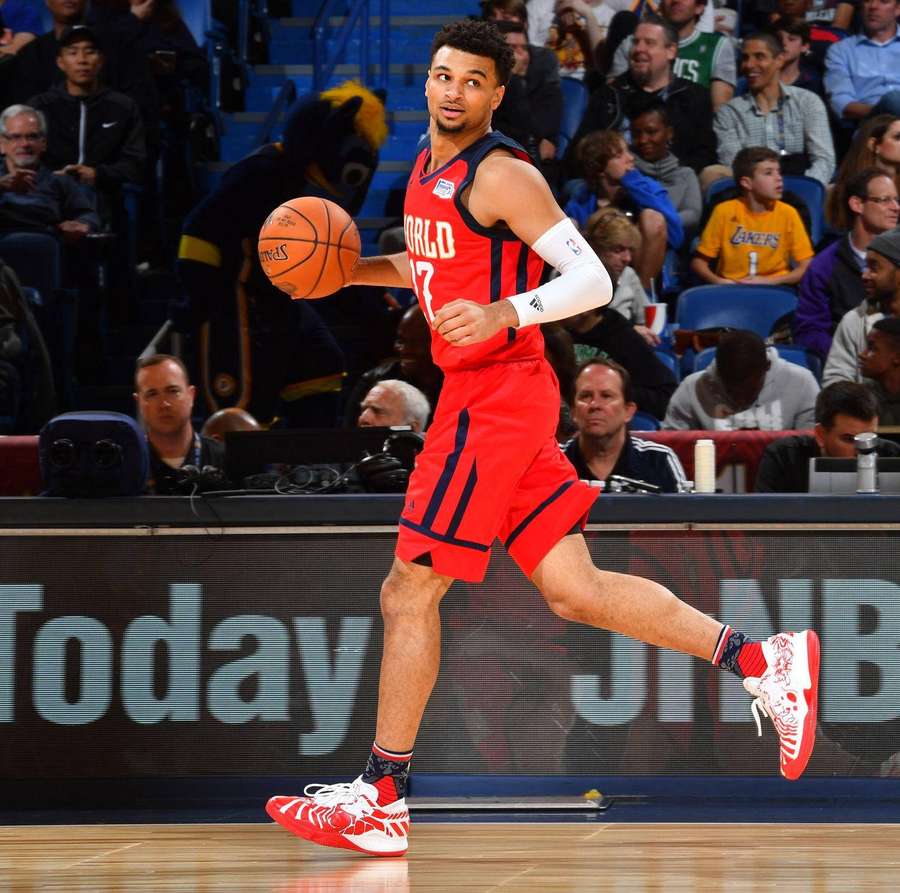 Professional basketball player dribbling during a game with fans watching. — Jamal Wallpaper