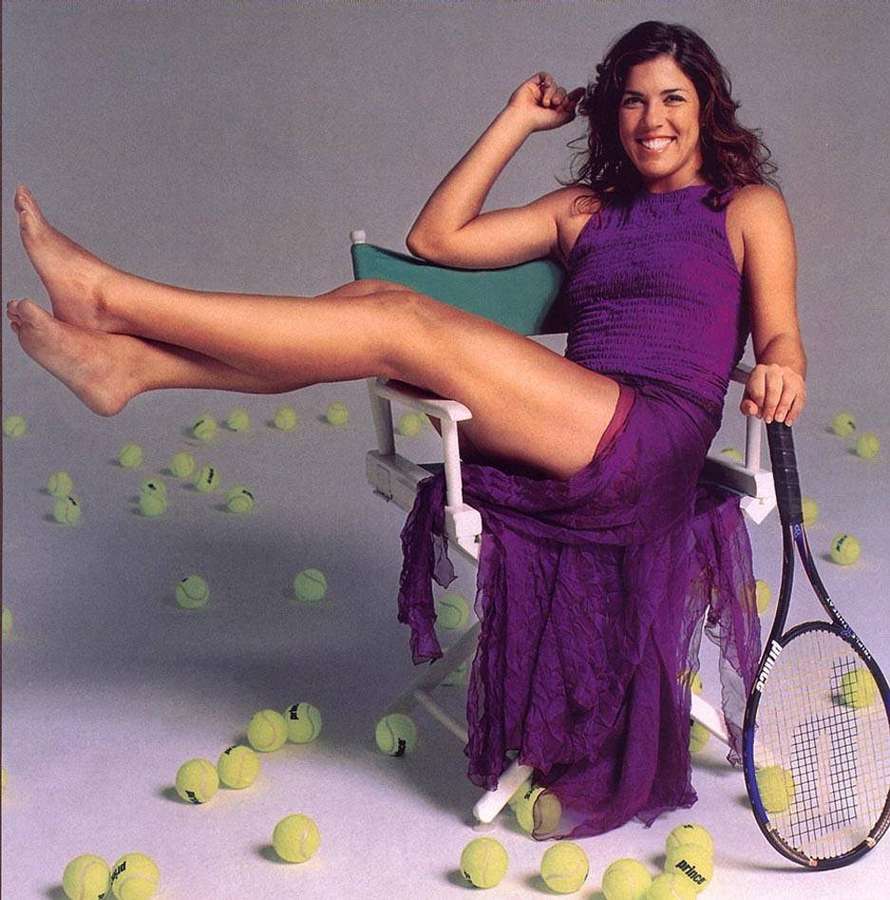 Woman in purple dress holding tennis racket surrounded by tennis balls. — Jennifer Capriati Background