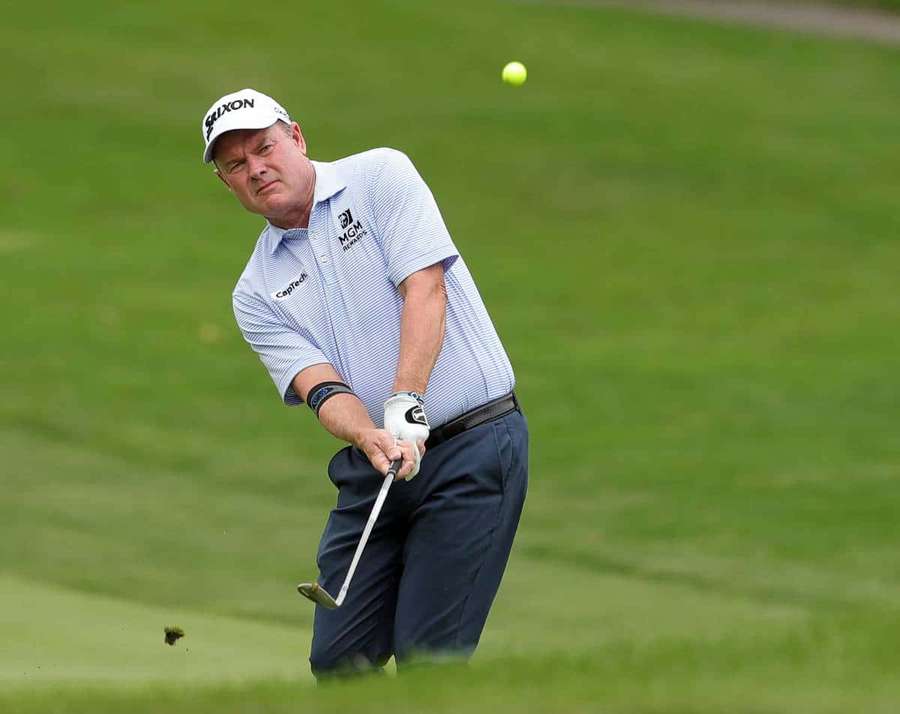 Golfer swinging club on green course with ball in air — Joe Durant Wallpaper