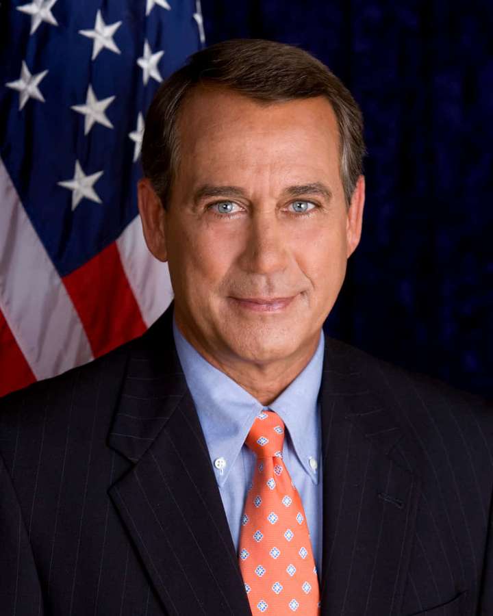 Man in suit and tie standing before American flag in official portrait. — John Boehner Wallpaper
