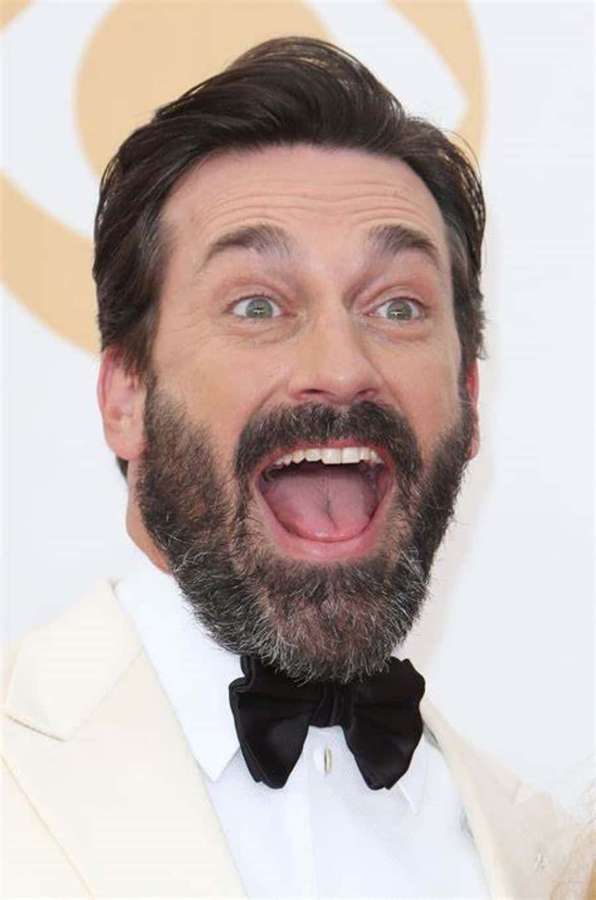 Man with beard laughing in cream suit and black bow tie. — Jon Hamm Picture