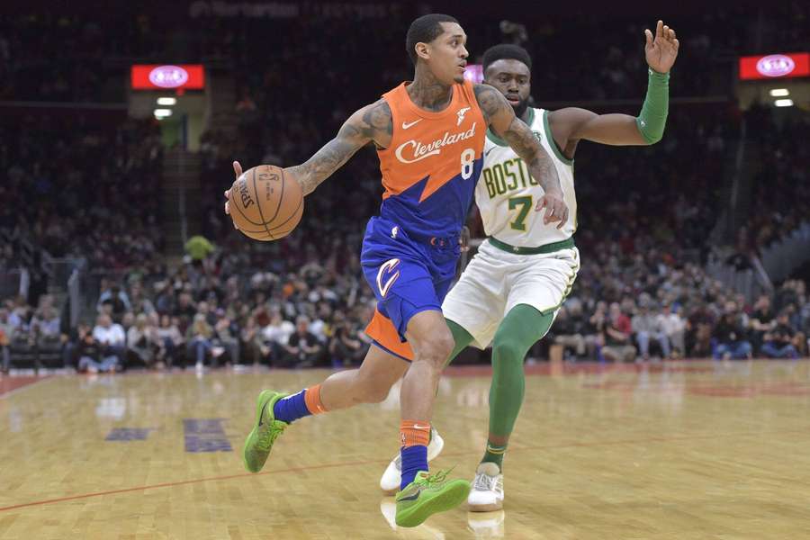 Cleveland Cavaliers player dribbling past Boston Celtics defender during NBA game. — Jordan Clarkson Background