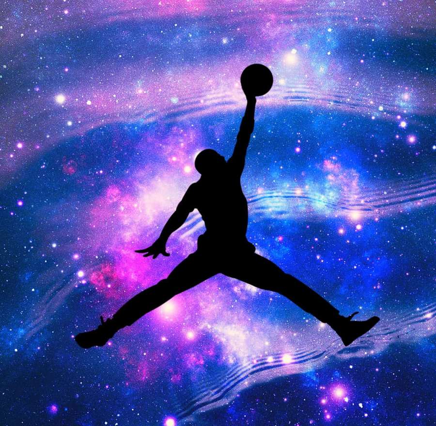 Silhouette of a basketball player mid-air against a colorful cosmic background. — Jordan Galaxy Wallpaper