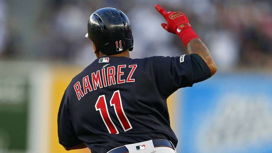 Baseball player Ramirez celebrates with raised finger wearing navy jersey and red gloves. — Jose Ramirez Wallpaper