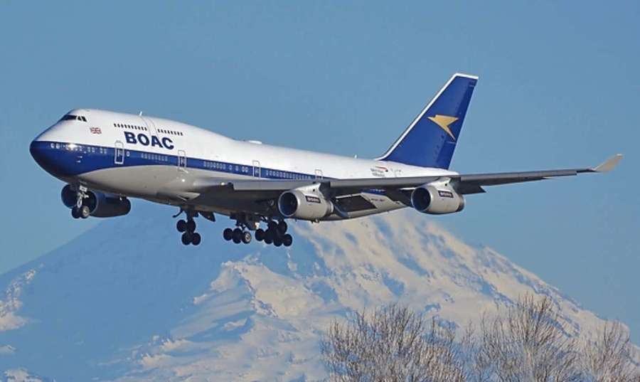 BOAC Boeing 747 airplane landing with snow-capped mountains in background. — Jumbo Jets Background
