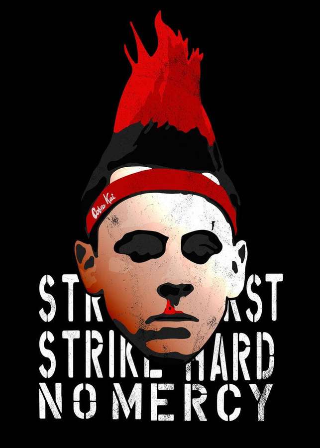 A masked figure with red mohawk and headband with text strike hard no mercy — Kai Background