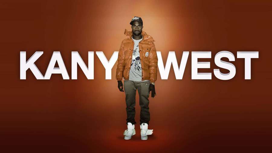 Kanye West in orange jacket and white sneakers standing in front of his name text. — Kanye West Background