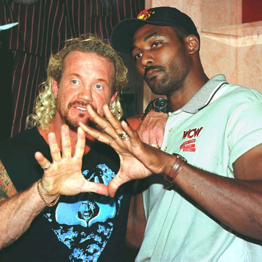 Two men making a heart shape with their hands indoors. — Karl Malone Background