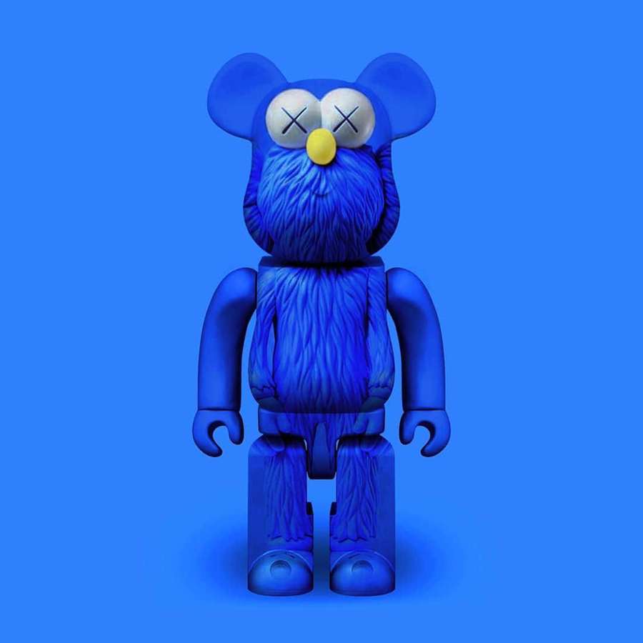 Blue furry bear toy with crossed eyes and yellow nose on blue background. — Kaws Bearbrick Wallpaper