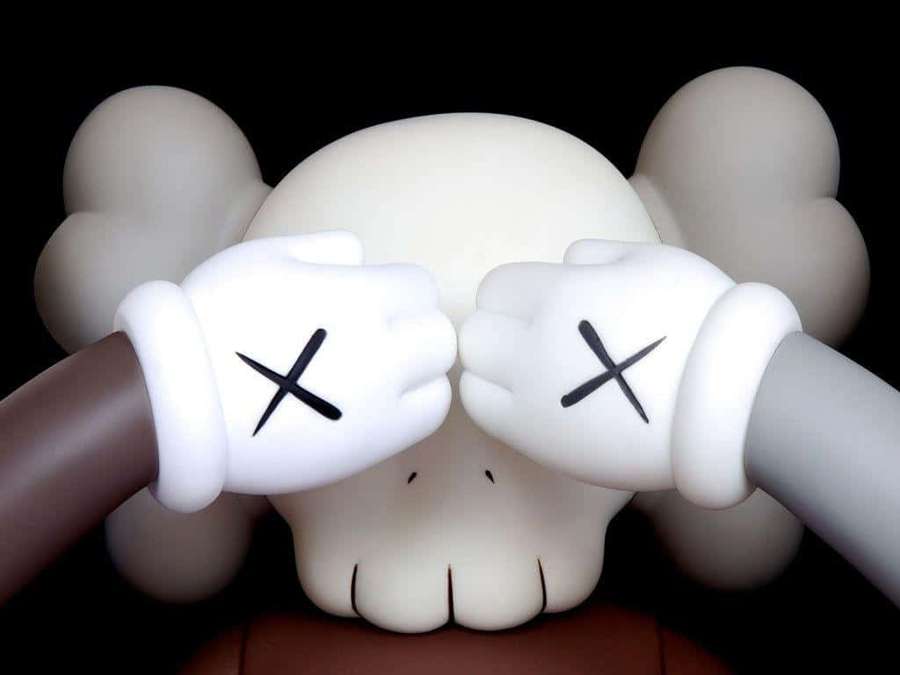 KAWS sculpture with X'd eyes covering its face with gloved hands. — Kaws Black And White Wallpaper