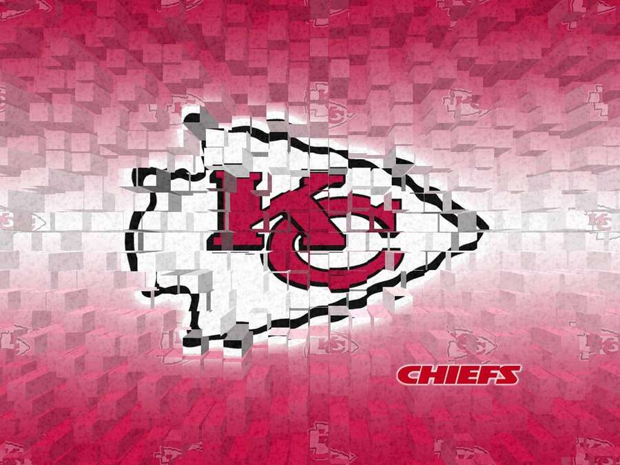 Kansas City Chiefs logo breaking through a pixelated wall with team marks. — Kc Chiefs Wallpaper