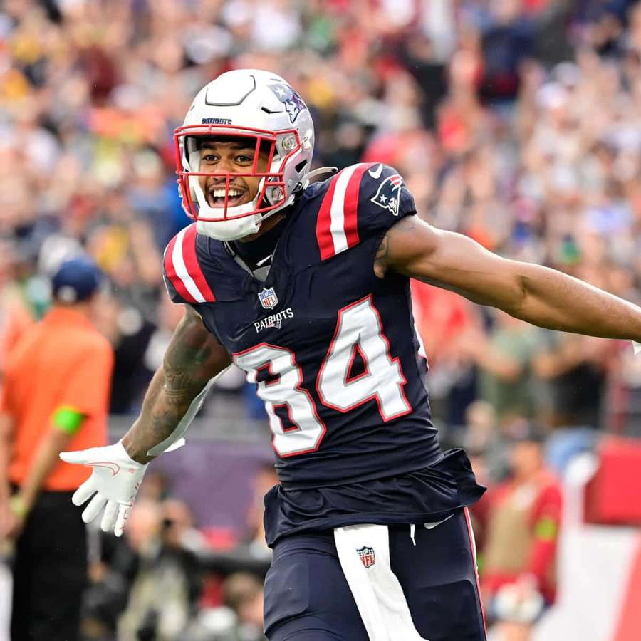 Football player number 34 celebrates victory on field with crowd behind. — Kendrick Bourne Wallpaper