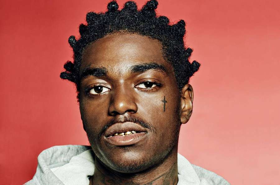 Portrait of a Black man with a cross tattoo on his cheek wearing a hoodie. — Kodak Wallpaper