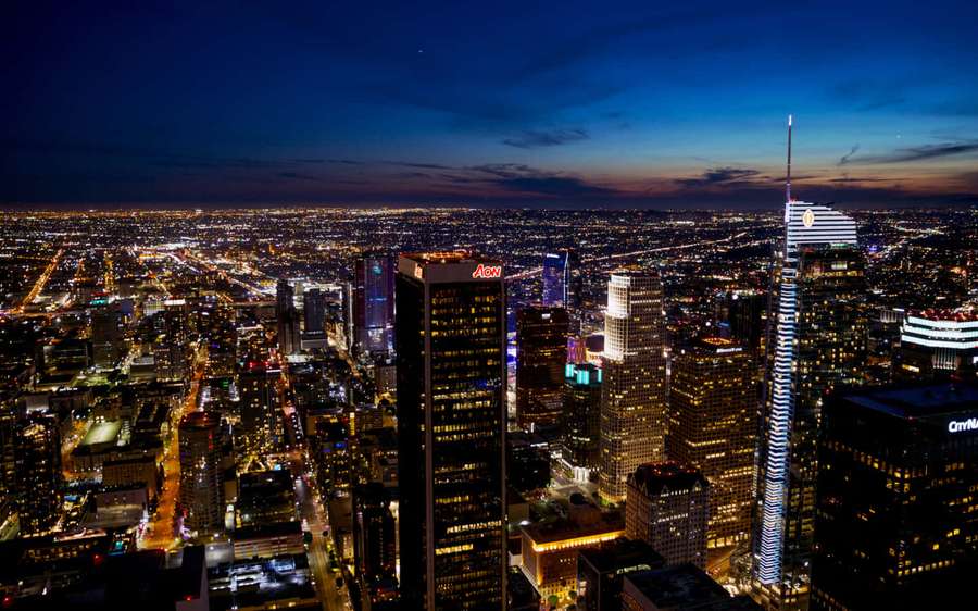 City skyline at dusk with glowing buildings and streets — La Background