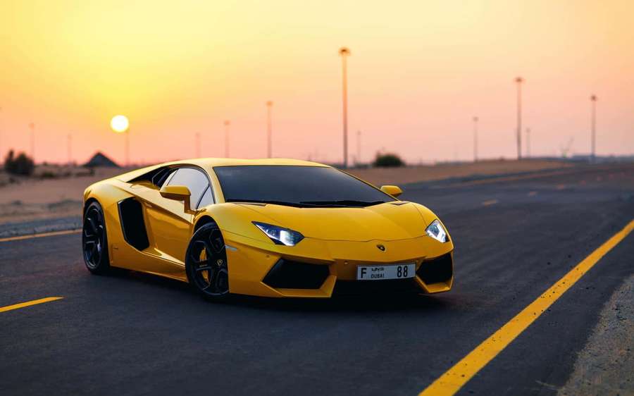 Yellow Lamborghini Aventador speeding on desert highway at sunset. — Lamborghini Background
