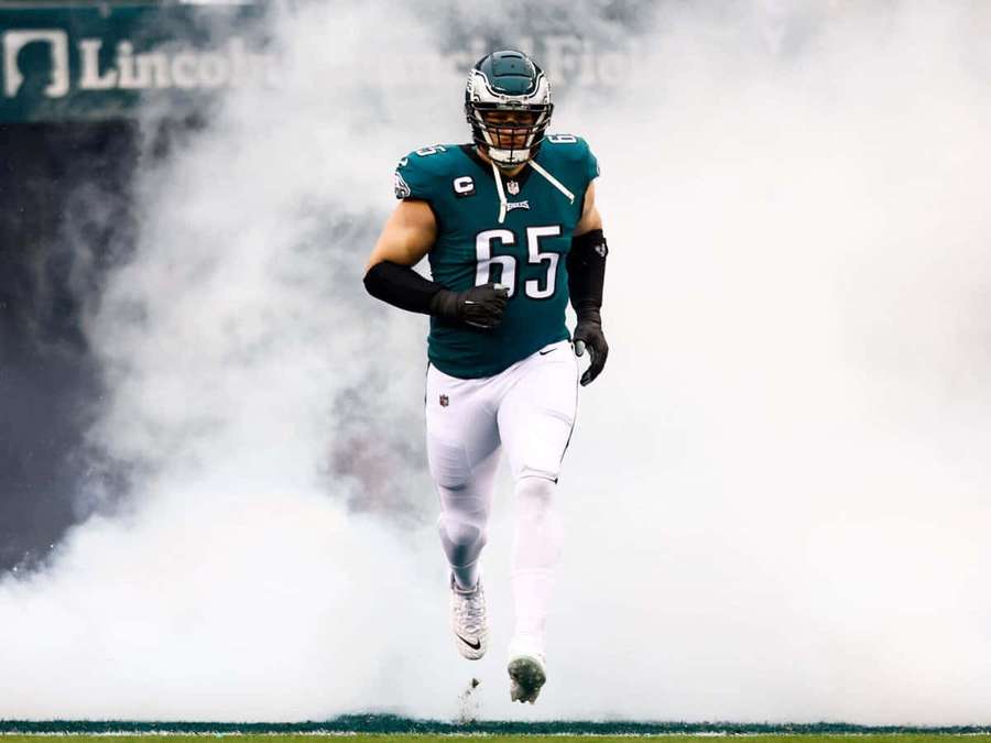 Footballspieler läuft durch Rauch auf einem Feld. — Lane Johnson Wallpaper
