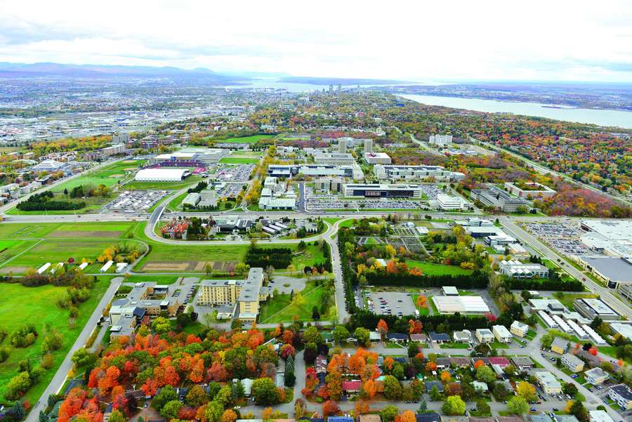 Aerial view of a city campus in autumn with colorful trees and buildings. — Laval Wallpaper