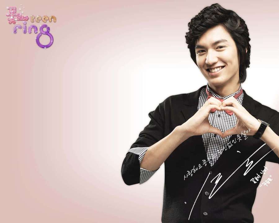 Young man smiling and making a heart shape with his hands. — Lee Min Ho Wallpaper