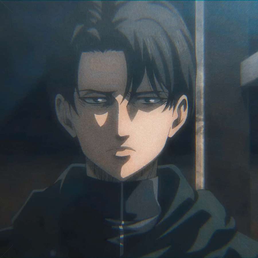 Anime character with dark hair and intense gaze in shadowy setting. — Levi Pfp Wallpaper