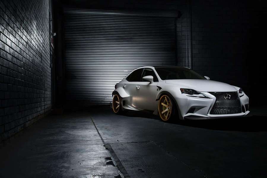 Valkoinen Lexus coupé kultaisilla vanteilla pysäköitynä hämärästi valaistuun tiiliautotalliin. — Lexus Rc Taustakuvat