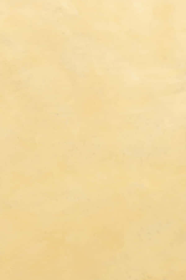 Krämig beige vägg med subtil fläckig textur och mjukt jämnt ljus — Ljus Tan bakgrund Bakgrunder