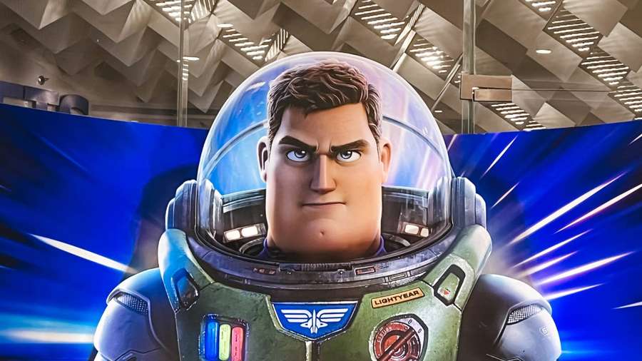 A serious astronaut in a green spacesuit with 'LIGHTYEAR' patch. — Lightyear Wallpaper