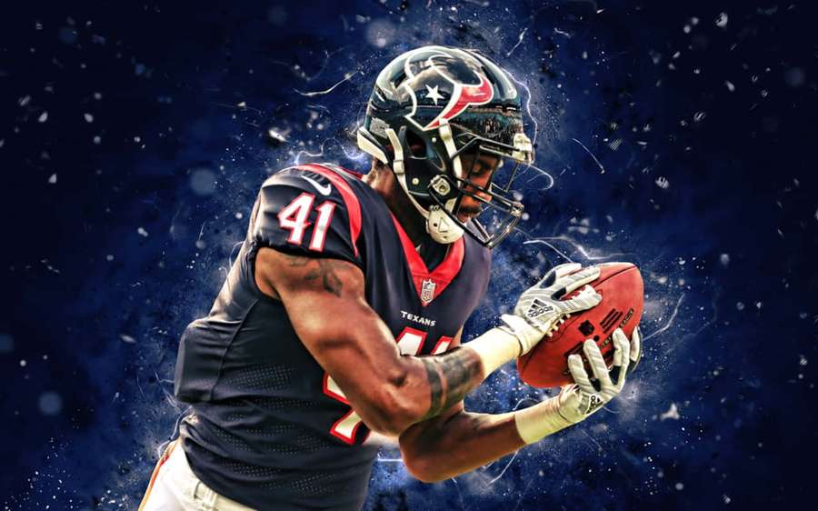 Football player in Texans uniform catching a ball with cosmic particle effects. — Linebacker Wallpaper