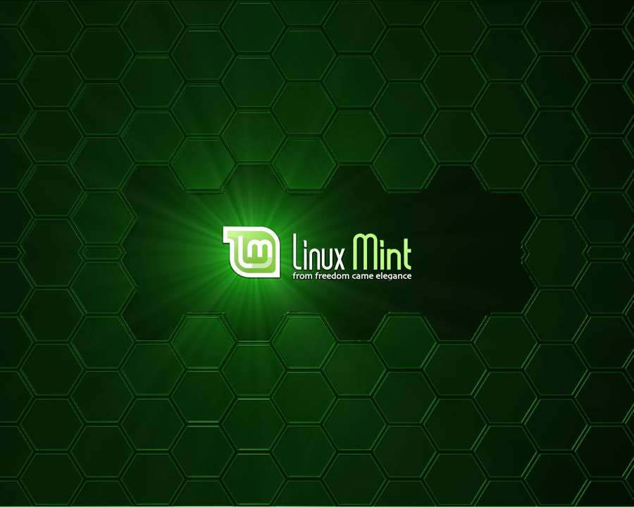 Linux Mint logo with glowing green rays on a dark green hexagonal grid. — Linux Mint Wallpaper