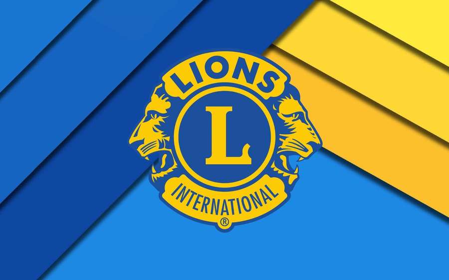 Lions International logo on blue and yellow geometric background — Lion Cub Background