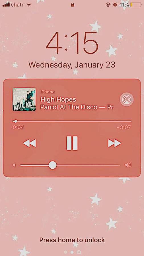 iPhone lock screen with pink star wallpaper and music player showing Panic! At The Disco — Lock Wallpaper