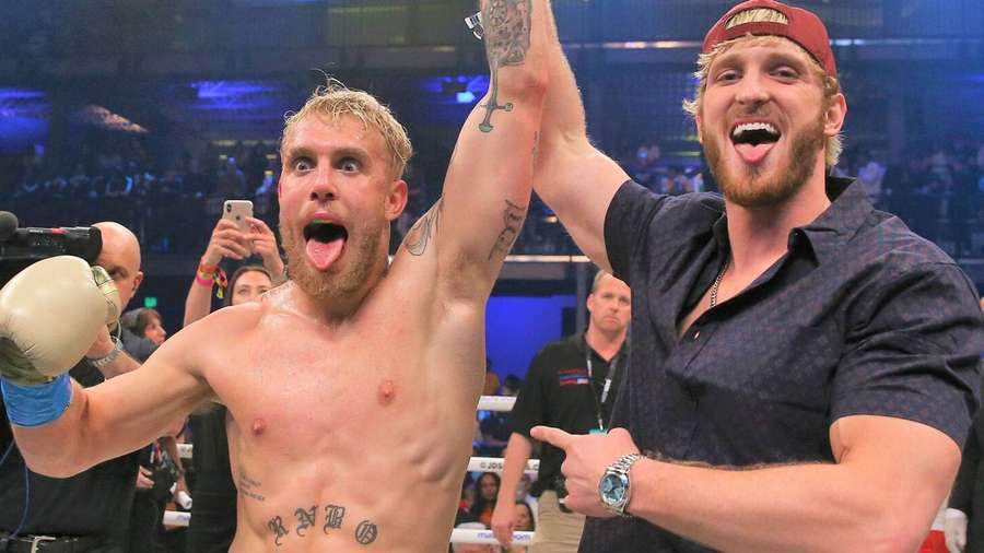 Boxer celebrates win in ring with cheering companion — Logan Wallpaper