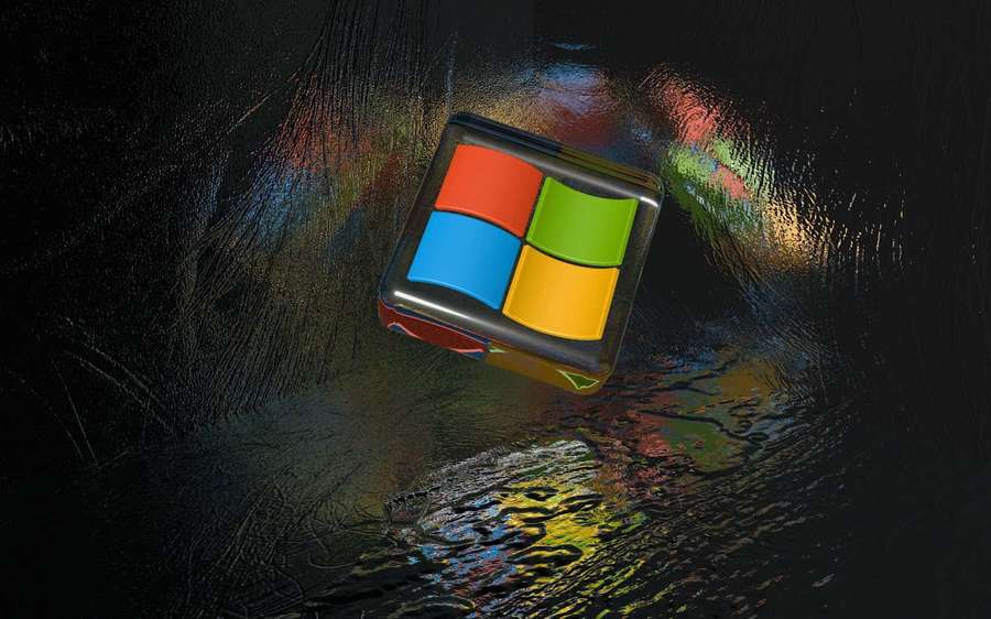 Glossy Windows logo cube reflecting rainbow colors on wet dark surface. — Logo Picture