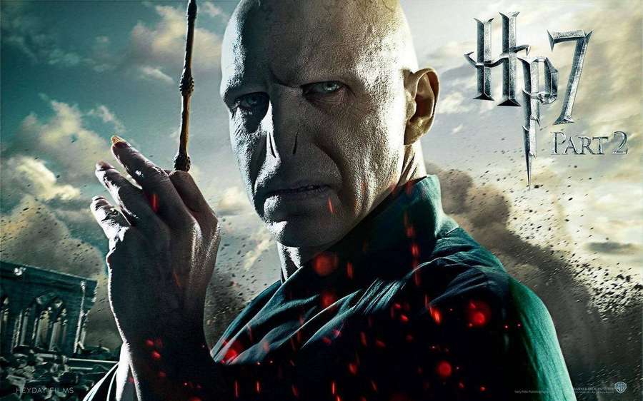 Voldemort wields his wand amid red sparks and stormy ruins. — Lord Voldemort Wallpaper