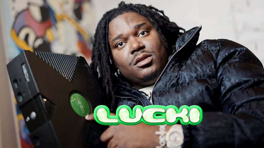Man holding Xbox console with green 'LUCKI' text overlay. — Lucki Wallpaper