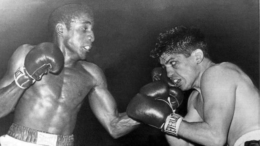 Two boxers in mid-fight with gloves raised and intense expressions. — Luis Rodriguez Wallpaper