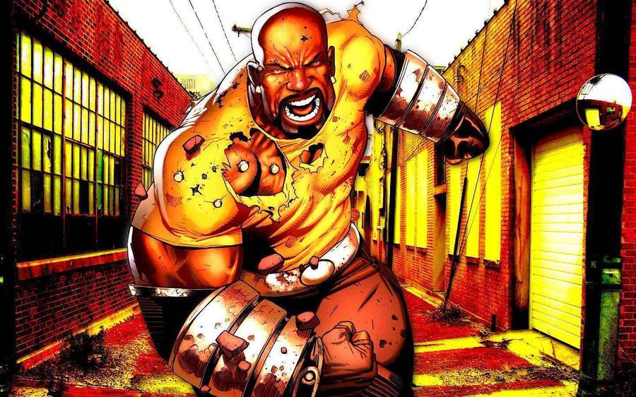 A muscular bald man roars in a brick alley with broken walls and yellow lighting. — Luke Cage Wallpaper