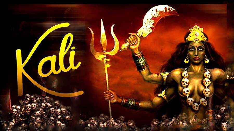Goddess Kali holding trident and scythe surrounded by skulls. — Maa Kali Wallpaper