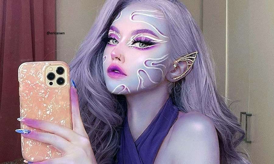 Person with fantasy makeup and lavender hair taking a mirror selfie. — Makeup Picture