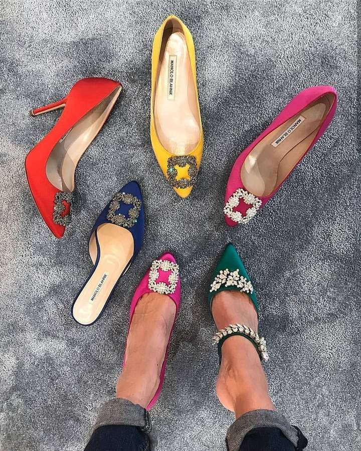 Five brightly colored high heels with jeweled details arranged on a gray carpet. — Manolo Blahnik Wallpaper